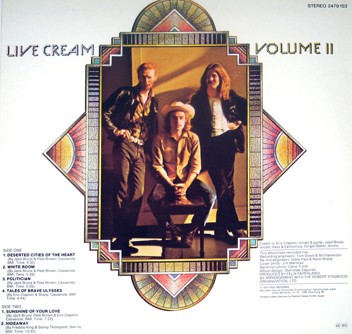 Back cover of 'Live Cream Volume II' by CREAM, released on RSO Records in 1972. The design mirrors the front cover, featuring an intricate Art Deco-inspired frame enclosing a photograph of the band members—Eric Clapton, Jack Bruce, and Ginger Baker. Clapton sits in the center, wearing a cowboy hat, flanked by Bruce and Baker in stylish 1960s rock attire. The tracklist is displayed on the left, while production credits, including producer Felix Pappalardi and engineer Tom Dowd, are on the right. The RSO Records logo and catalog details appear in the top right corner.