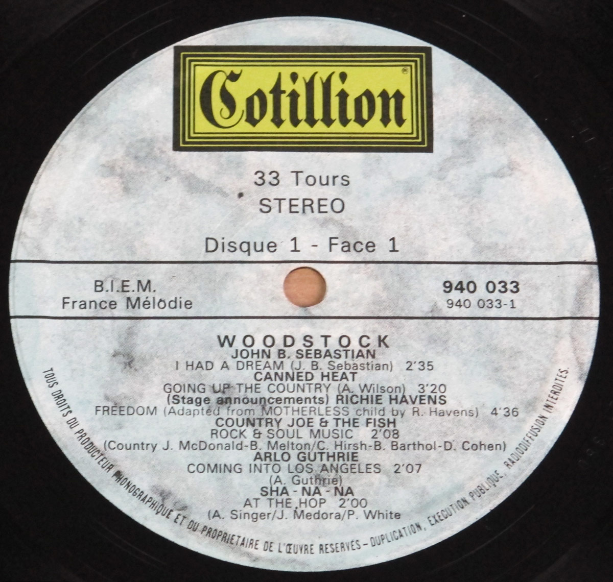 Close-up of the record label from the Woodstock 69 Original Movie Soundtrack France 3LP, featuring Cotillion branding, track listing for Side One, and catalog number 940 033.