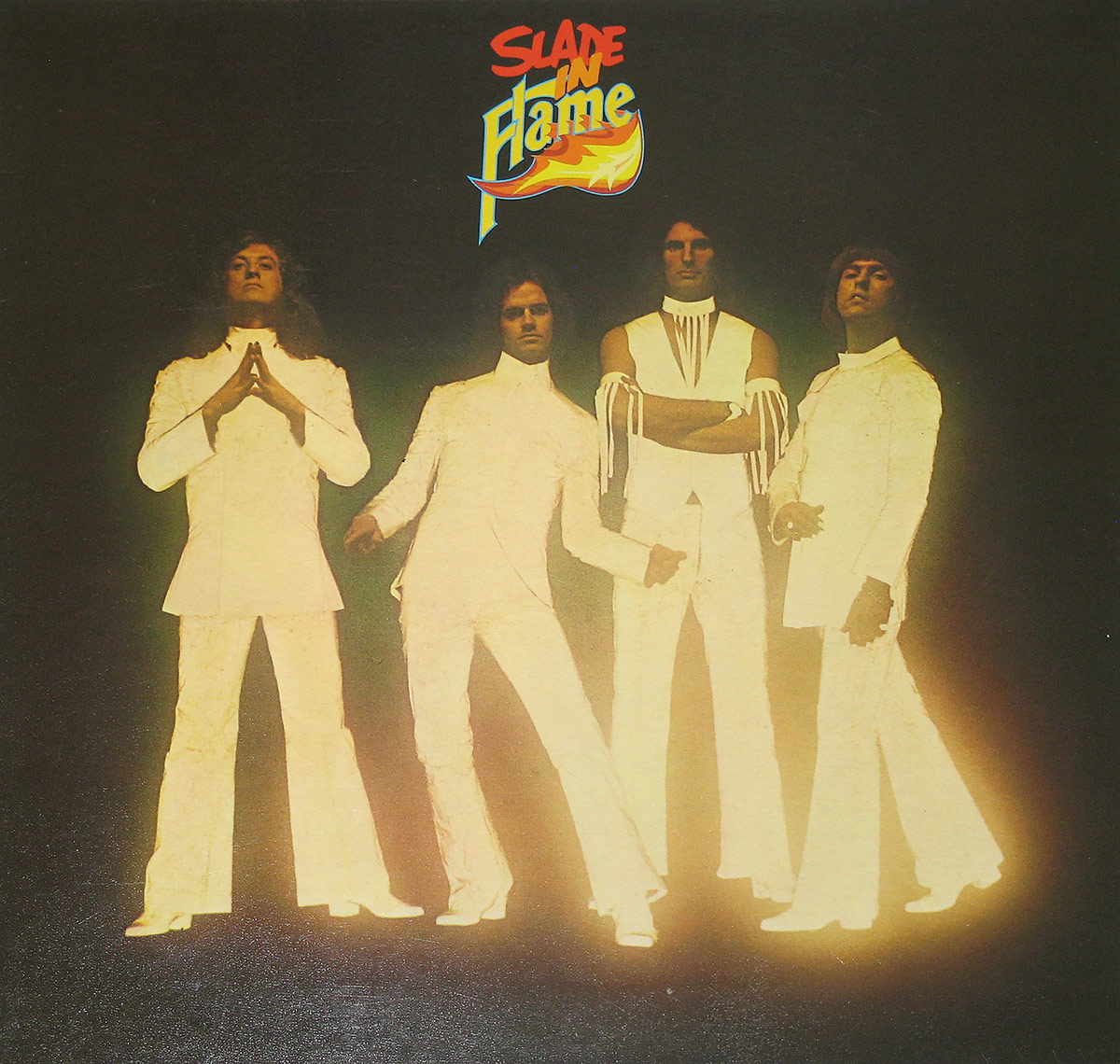 Slade - In Flame album cover featuring the band members in white suits against a dark background, with the album title in vibrant, fiery text at the top