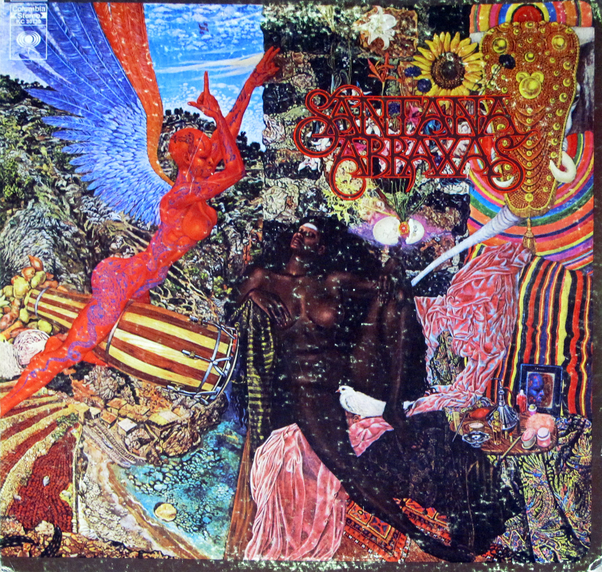Album cover of Santana’s Abraxas featuring Mati Klarwein’s surreal artwork Annunciation. The image depicts a red angelic figure with blue wings on the left, a reclining Black woman with a white dove on her hip in the center, and a vibrant, psychedelic background filled with colorful patterns, fruit, and landscapes. The band name Santana and album title Abraxas are written in ornate red lettering in the upper-right corner.