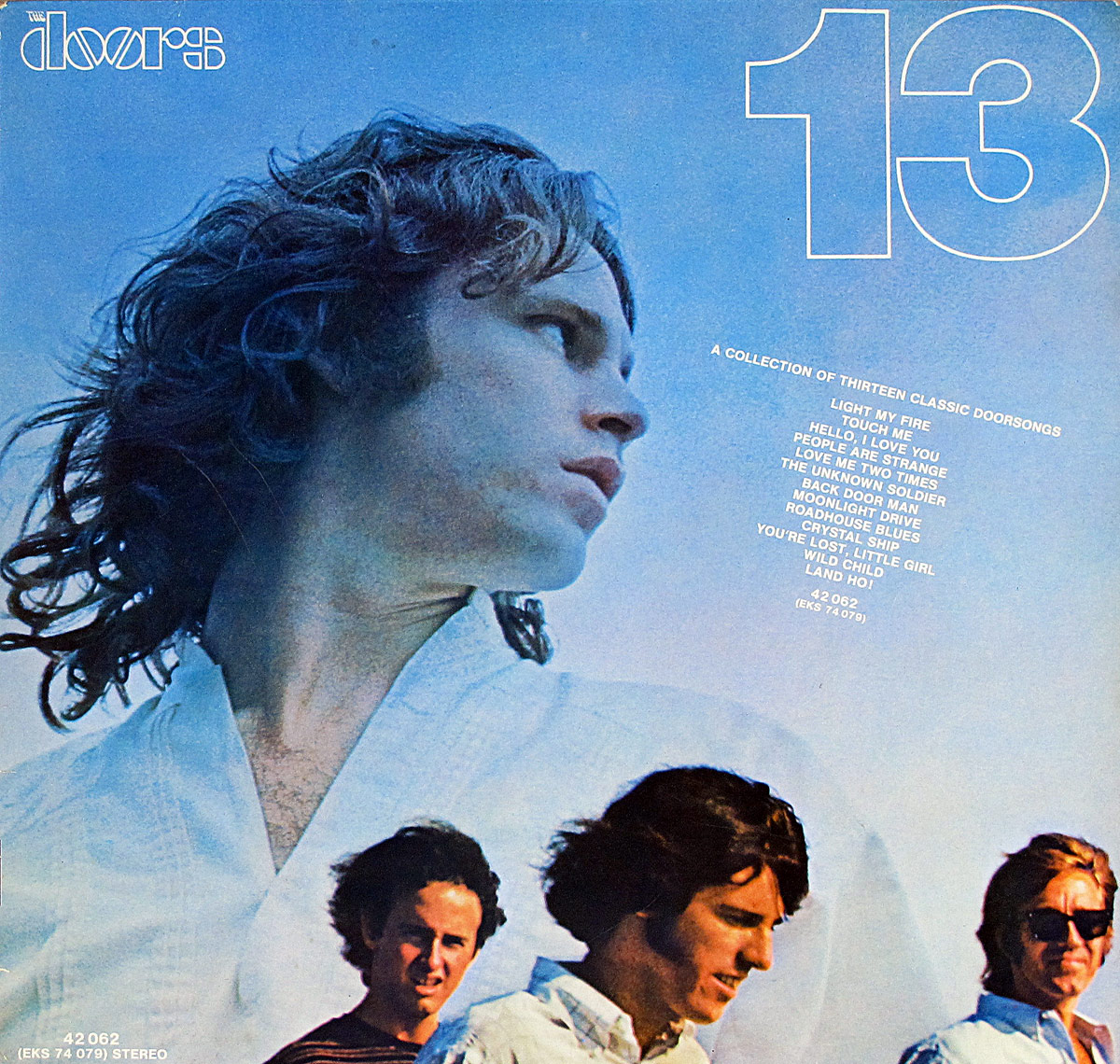 Front cover of The Doors 13 album showing Jim Morrison in a blue-tinted portrait, surrounded by smaller images of the band members, with bold yellow band logo and album title against a black background.