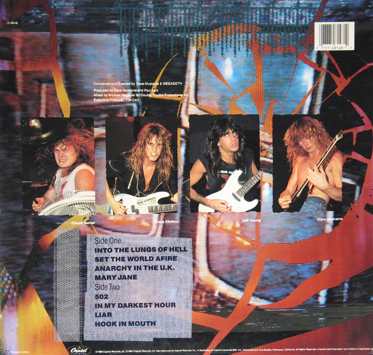 High resolution image of the back cover of Megadeth's 1988 USA vinyl release So Far, So Good... So What!. The layout features four separate performance shots of the band members: Chuck Behler behind his drum kit, David Ellefson on bass with intense expression, Jeff Young focused while playing guitar, and Dave Mustaine mid-riff on his black guitar. The images are arranged horizontally across the center. The background is a collage of shattered glass and metallic textures, continuing the album’s apocalyptic design. Below the band photos is the printed tracklist with bold capital letters dividing Side One and Side Two. Production credits including Dave Mustaine, Paul Lani, Michael Wagener, and Tim Carr are printed above. A Capitol Records logo and copyright text appear at the bottom.