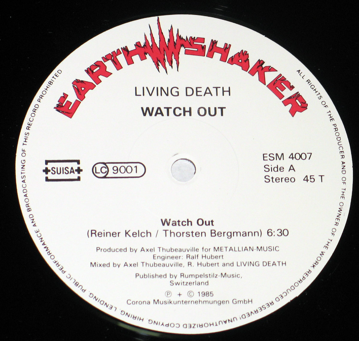 Record label of the “Watch Out!” album by Living Death, featuring the Earthshaker Records logo in red with jagged edges, SUISA copyright logo, LC 9001 label code, catalog number ESM 4007, and legal copyright information on a white background