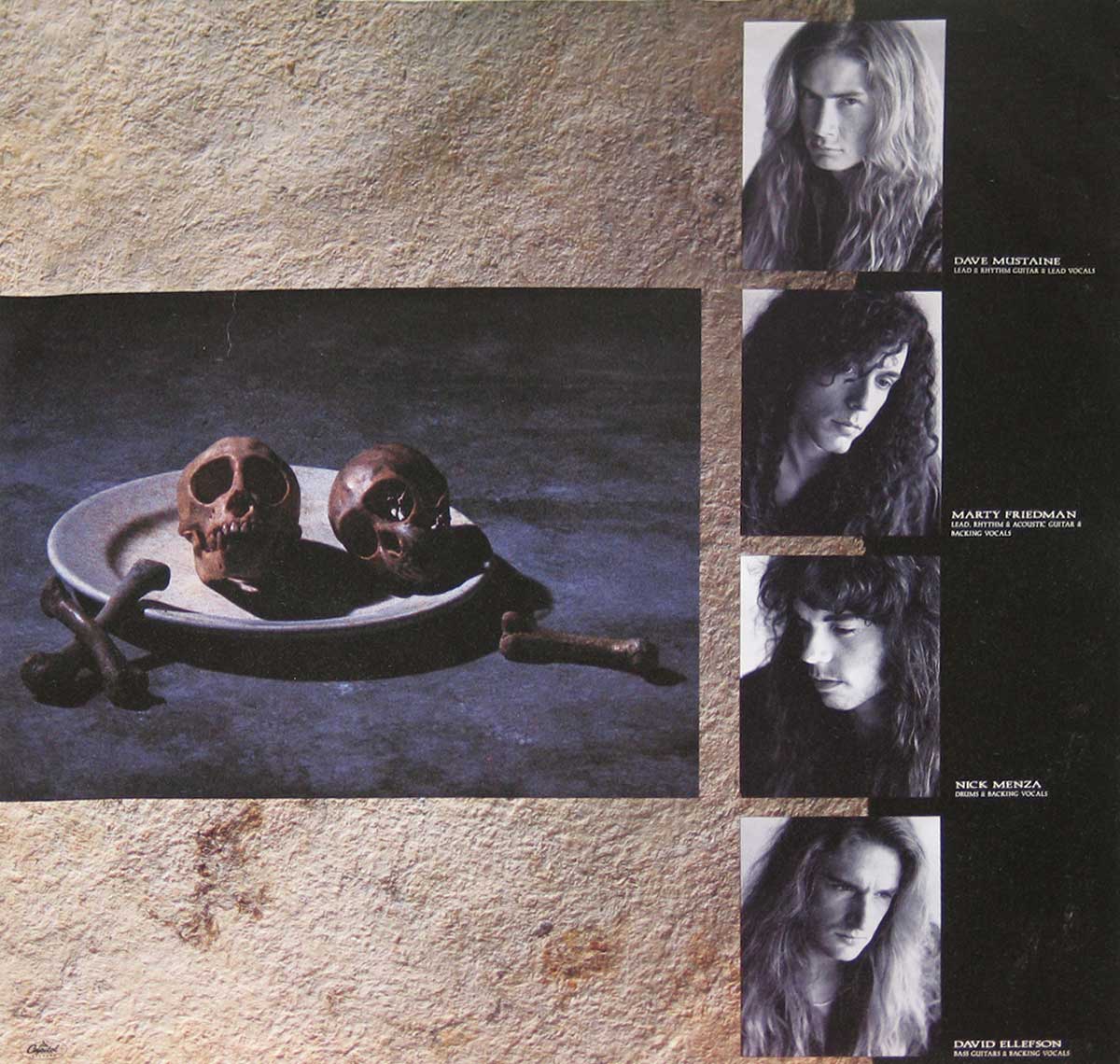 Megadeth Countdown to Extinction inner cover featuring portraits of band members Dave Mustaine, Marty Friedman, Nick Menza, and David Ellefson, alongside a chilling still life with two skulls on a plate.