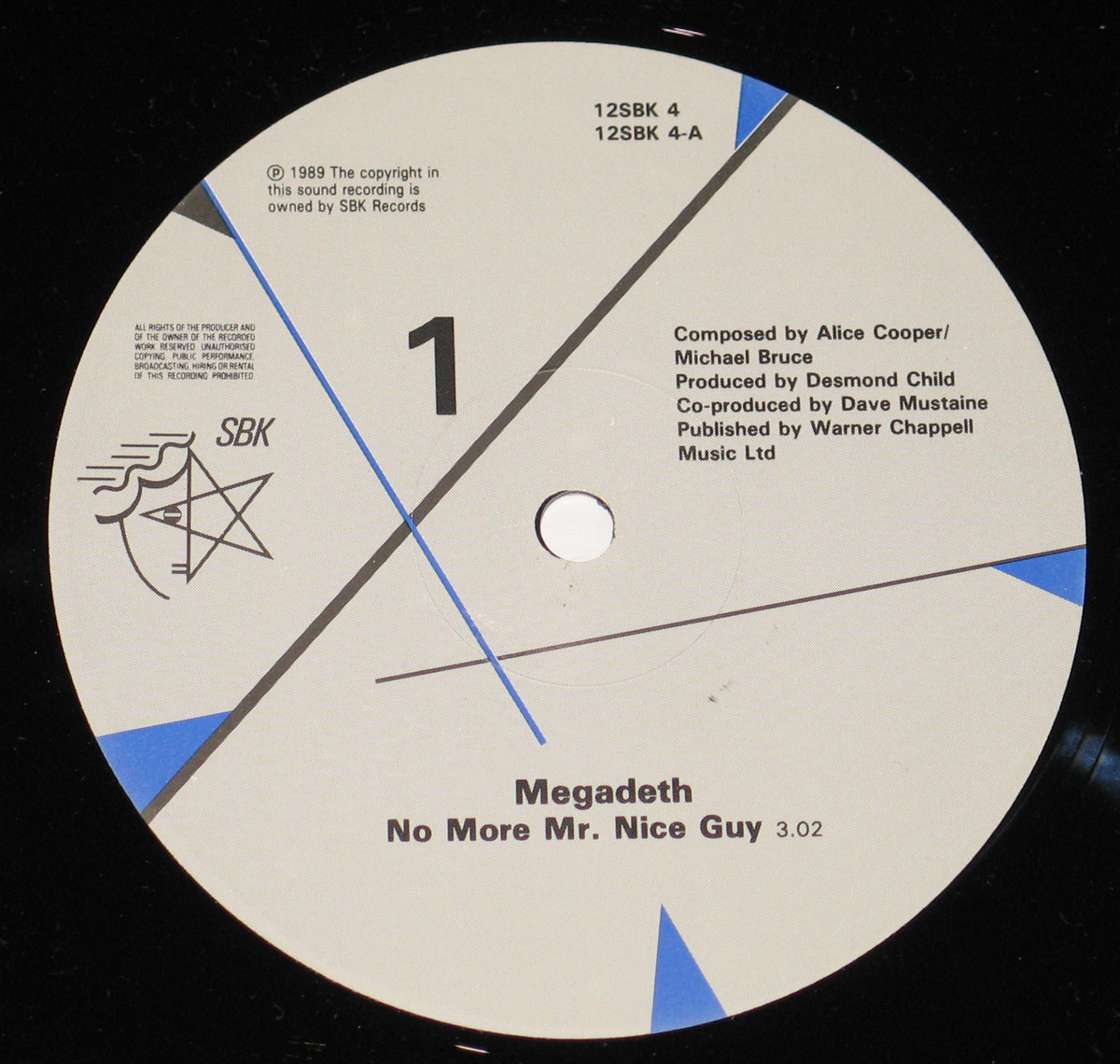 Close-up of Side One record label for Megadeth - No More Mr. Nice Guy (USA) Vinyl. White background with black text, SBK Records logo, track information, and production credits.