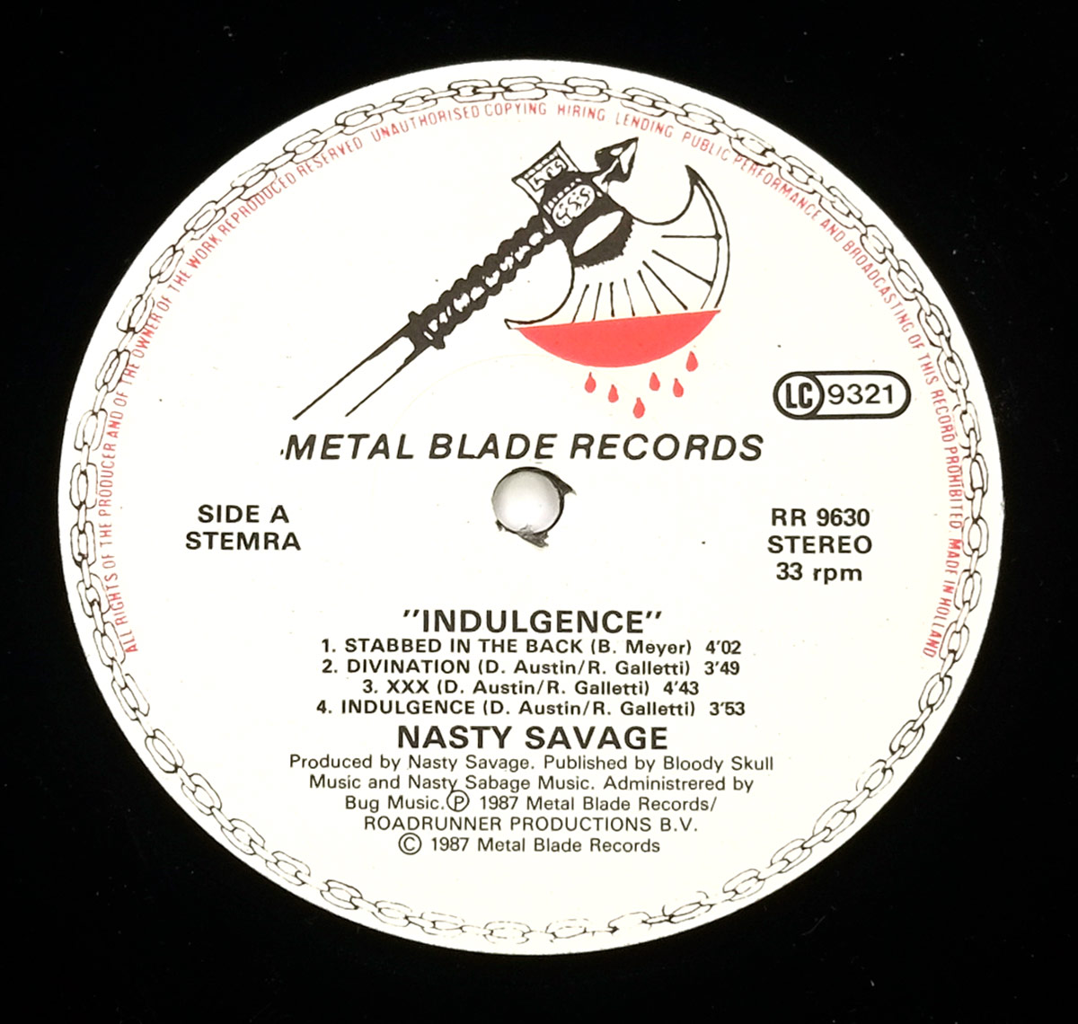 Close-up of Side One record label for NASTY SAVAGE - Indulgence. Features the Metal Blade Records axe logo, track listing, catalog number RR 9630, and production credits.