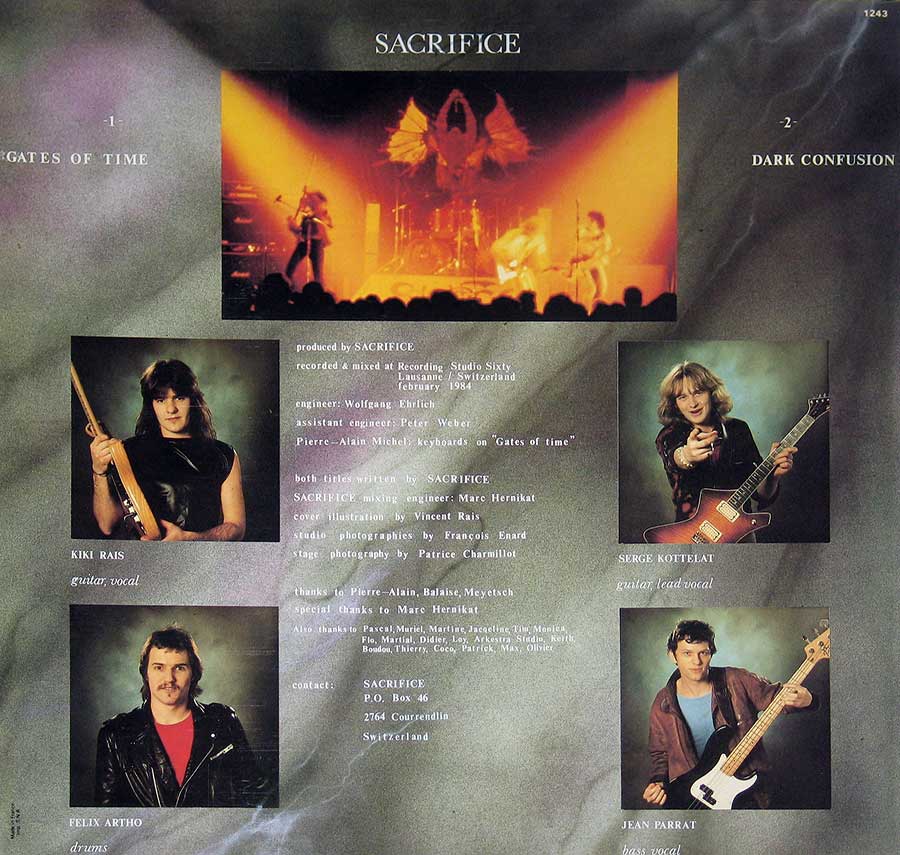 Back cover of Sacrifice’s album featuring a live performance photo at the top with fiery red and orange lighting, silhouetted audience, and a wing-like motif above the stage. Below are portrait photos of the band members: Kiki Rais (guitar, vocal) holding a guitar, Serge Kottelat (guitar, lead vocal) pointing with a guitar, Felix Artho (drums) in a leather jacket, and Jean Parrat (bass, vocal) holding a bass guitar. The background is a misty grey with production credits and acknowledgments listed in the center-right.