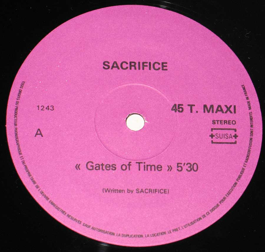 agenta record label for Sacrifice’s Gates of Time 45 T. MAXI. The band name SACRIFICE is in bold black letters at the top. The track title “« Gates of Time » 5’30 is centered, with a credit “(Written by SACRIFICE)” beneath it. The label includes the catalog number 1243 on the left and STEREO with the SUISA copyright logo on the right. Legal copyright text lines the outer edge.’