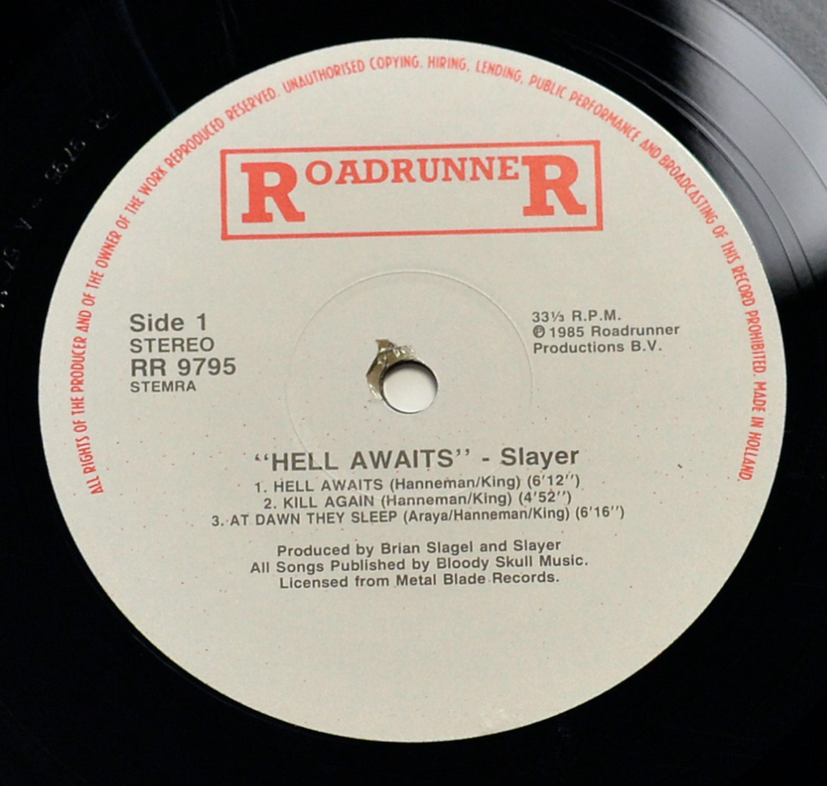 Side 1 label of Slayer's Hell Awaits LP on Roadrunner Records, showing tracklist, publishing info, and red Roadrunner logo, pressed in the Netherlands.