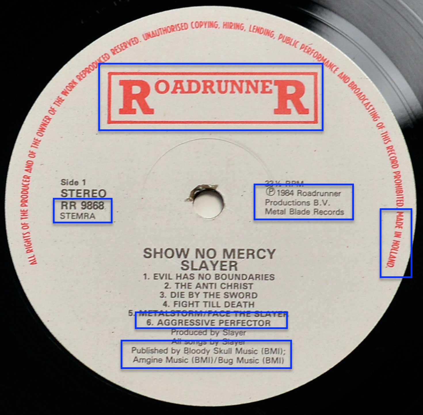 Close-up of Slayer's Show No Mercy Side 1 record label from the 1984 Roadrunner Netherlands pressing, listing six tracks including bonus track Aggressive Perfector.