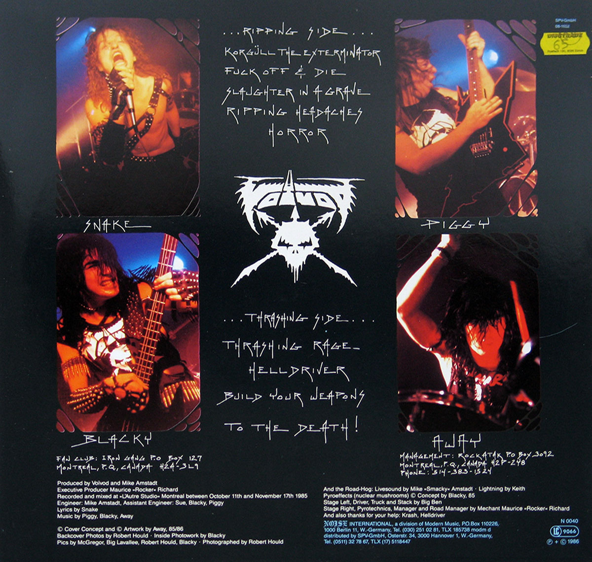 Voivod Rrröööaaarrr album back cover: A collage of black and white photos of the band members performing live, interspersed with track listings and credits. The band's logo, a stylized 'V' with a cross, is prominently featured in the center. The photos capture the energy of their performance, with band members shown playing instruments and singing. The track listings are written in a handwritten style, adding to the raw feel of the album. The credits are printed in smaller text, providing information about the production and personnel involved in the album.
