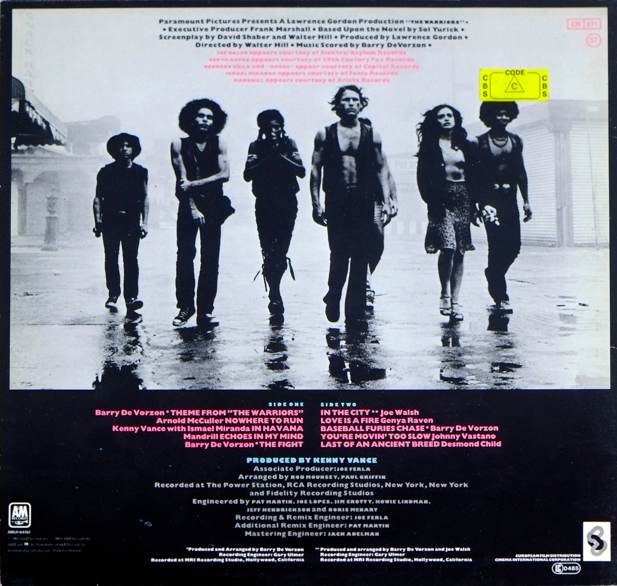 Back cover of The Warriors Original Motion Picture Soundtrack album, featuring a black-and-white photo of the gang walking through a misty street, with track listing and production credits below.